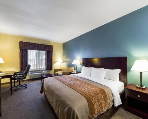 a hotel room with a large bed and a desk at Quality Inn Ingleside - Corpus Christi in Ingleside
