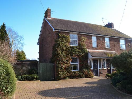 a red brick house with ivy growing on it at Pam's Plaice in Offord Cluny
