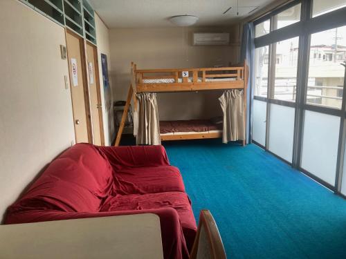 a living room with a couch and a bunk bed at BIGJOY INN Hirokouji in Miyako-jima