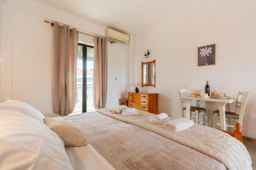 a bedroom with a large bed with towels on it at Sailor's Apartments Kavos in Kavos