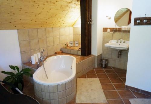 a large bathroom with a tub and a sink at Biohof Prannleithen - Knusperhaus in Yspertal