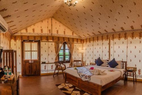 a bedroom with a large bed in a room at Desert Story Night Camp in Jaisalmer