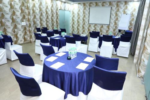 a room with blue and white tables and chairs at Nivasaah in Jāmb