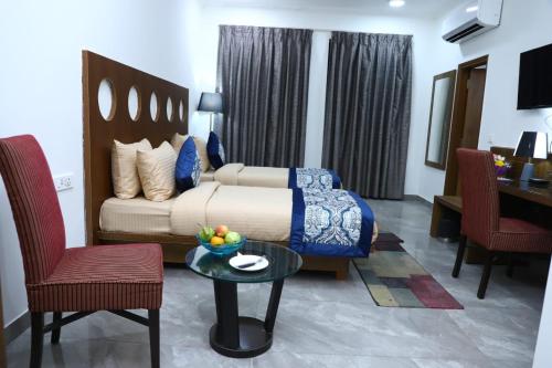 a bedroom with a bed and a table and chairs at Nivasaah in Jāmb