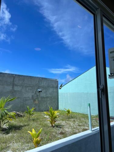 a view of a building from a window at Vaadhee Homestay in Guraidhoo