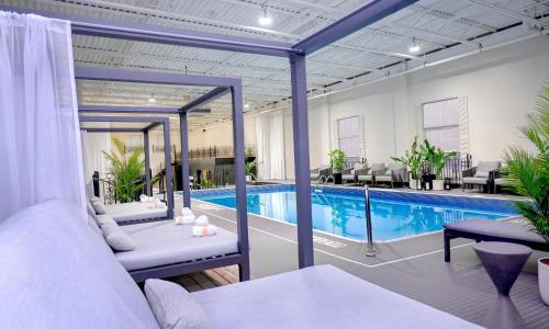 a hotel room with a swimming pool and a bed at The Brock Niagara Falls Fallsview, Tapestry by Hilton in Niagara Falls