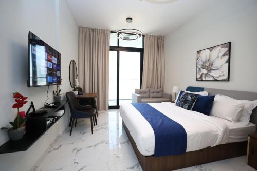 a hotel room with a bed and a desk and a television at Maryah Island Studio Near Galleria Mall & ADGM in Abu Dhabi