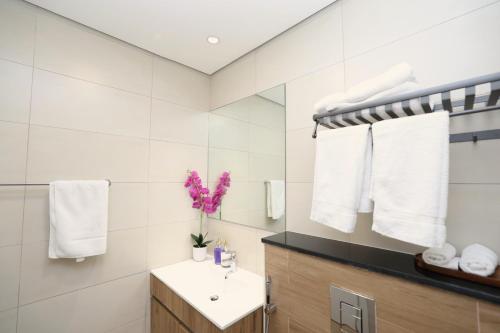 a bathroom with a sink and a mirror at Maryah Island Studio Near Galleria Mall & ADGM in Abu Dhabi