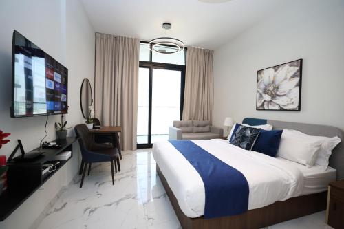 a hotel room with a bed and a desk and a television at Maryah Island Studio Near Galleria Mall & ADGM in Abu Dhabi
