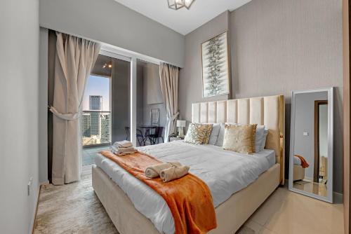 a bedroom with a large bed and a balcony at Reva Hotel Apartment Downtown in Dubai