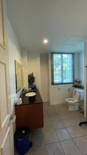 a bathroom with a sink and a toilet at 6A SANTUBONG SUITES by MF in Kuching