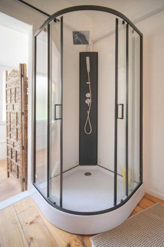 a glass enclosure in a room with a clock at FRGK "4 Suites Privées Exclusives" in Cannes