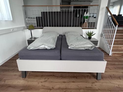 a bed with two pillows on it in a room at Grosse Einzimmerwohnung/Büro/Showroom in Seengen