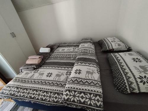a bedroom with two beds with pillows and a blanket at Vikend kuća Davor in Risovac