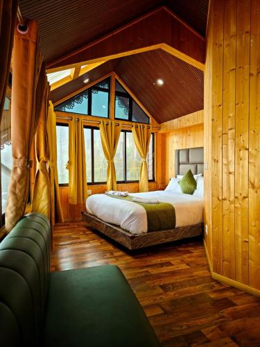 a bedroom with a bed and a couch in a room at Beyond Baari Inn in Darjeeling