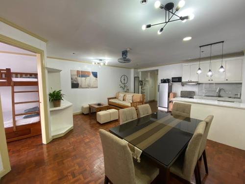 a kitchen and living room with a table and chairs at LJ's Burnham Homestay in Baguio