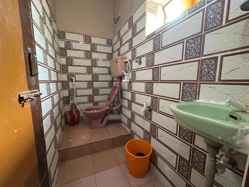 a bathroom with a sink and a toilet at Monalisa Lodge in Vishnupur