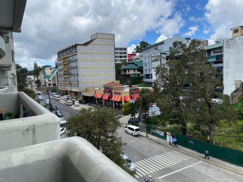 a view of a city street from a balcony at LJ's Burnham Homestay in Baguio