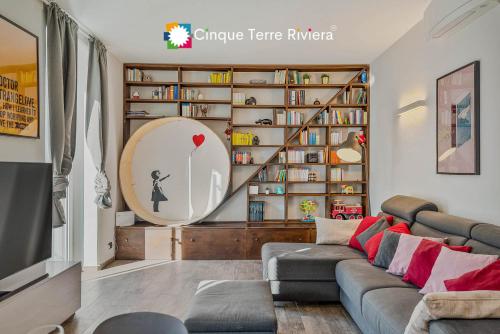 a living room with a couch and a book shelf at Graffiti House Luxury Apartment in La Spezia