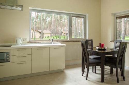 a kitchen with a table and a sink and a window at Park-Hotel Tihiy Les in Prokhorovka