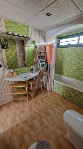 a bathroom with a sink and a bath tub at Lukite House in Tías