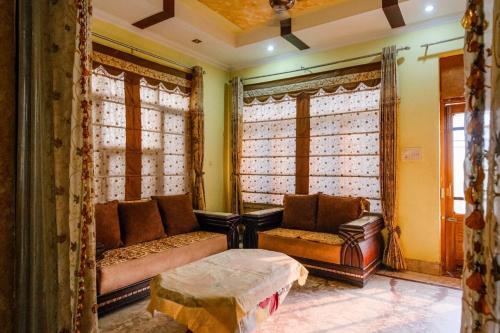 a living room with a couch and a table at Meraki Homes in Karnal