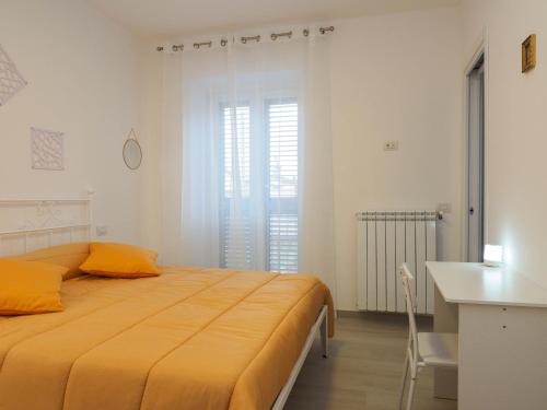 a bedroom with a large yellow bed and a desk at Affittacamere 1888 in Pietrelcina