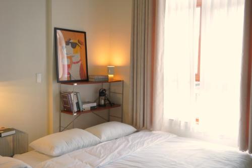 a bed sitting in a room with a window at Lemi - Homestay in Hue in Hue