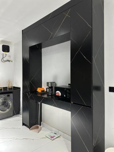 a black wall with a mirror in a room at Emerald Enclave Residence in Gwarinpa