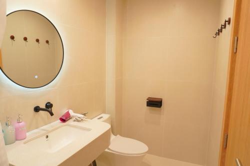 a bathroom with a sink and a toilet and a mirror at Lemi - Homestay in Hue in Hue
