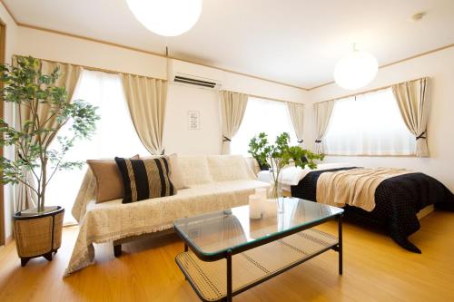 a living room with a couch and a table at 伯旺ビル 403 in Kanazawa