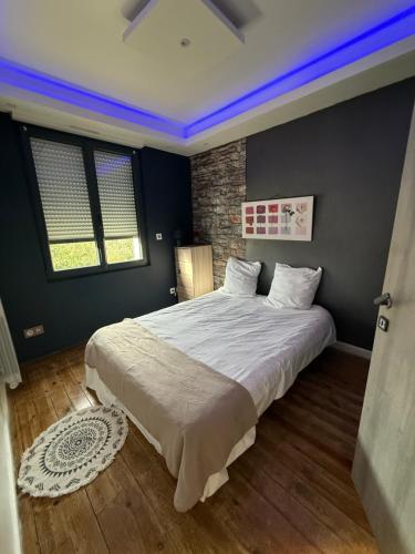 a bedroom with a large bed in a room at Maison in Maisdon-sur-Sèvre