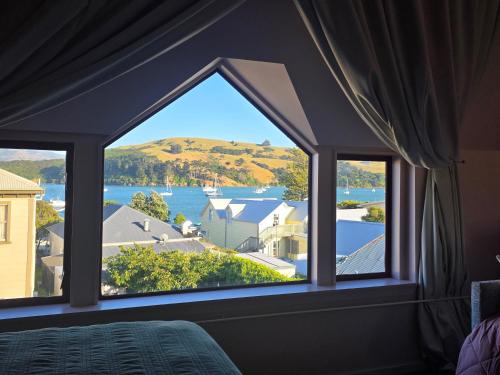 a bedroom with a window with a view of the water at Seaview Akaroa in Akaroa