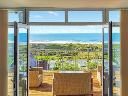 a living room with a view of the ocean at Pendine Beach Apartment in Pendine