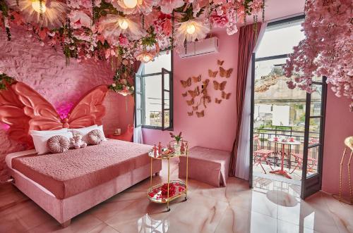 a pink bedroom with a bed in a room with flowers at Fairytale Athens - Luxury Suites in Athens