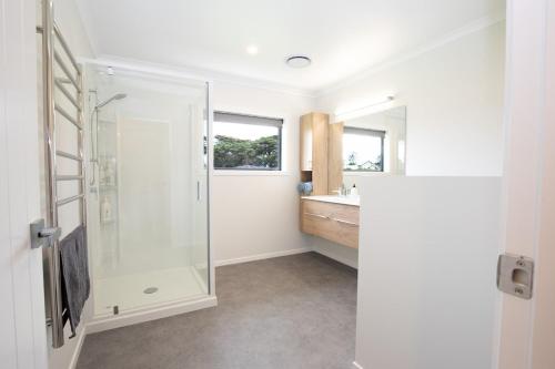 a bathroom with a shower and a sink at Mahaki Escape in Pahautea