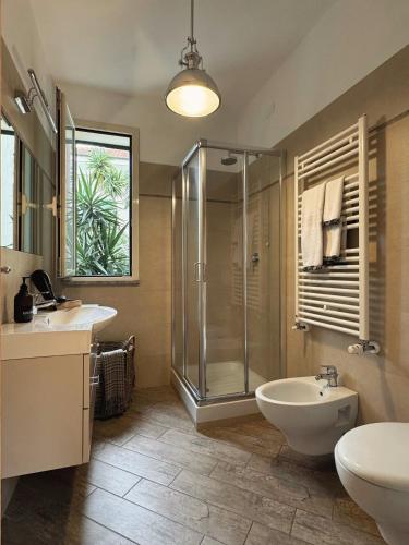 a bathroom with a shower and a sink and a toilet at Scirocco - Villa Marina in Marina di Andora