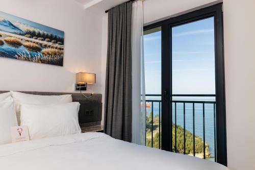 a bedroom with a bed and a large window at Best Western Plus Trabzon in Trabzon