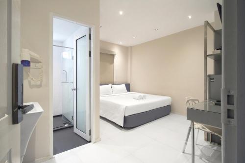 a bedroom with a bed and a sliding glass door at My Hotel Pratunam in Bangkok
