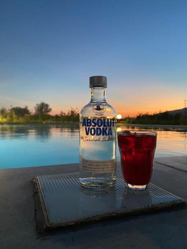 a bottle of vodka and a drink on a table at Casamora in Edremit