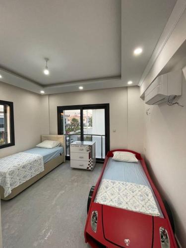 a room with two beds and a red car in it at Master Vi in Dalaman