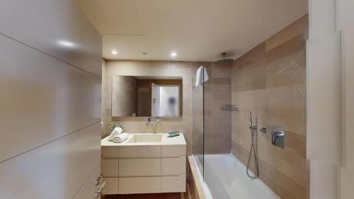 a bathroom with a sink and a shower and a tub at Rental Israel-Mamila Residences 14 in Jerusalem