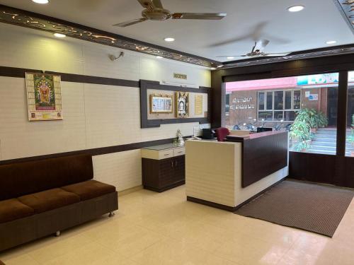 a waiting area of a fast food restaurant with a counter at Manjusri Paradise in Bangalore