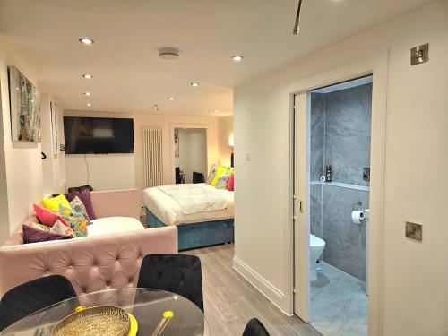 a living room with a couch and a bed at Stylish & Central Design Apartment- 3 Beds in Edinburgh