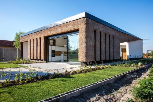 a brick building with a large glass door at Artkazal in Mórahalom