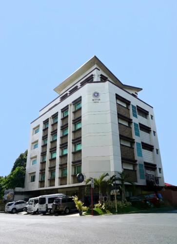 a large white building with cars parked in front of it at Star Hotel Davao in Davao City