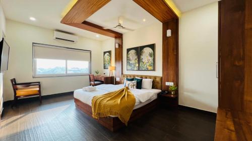 a bedroom with a bed with a yellow blanket on it at Amani by BluO - Boutique Hotel Goa in Anjuna