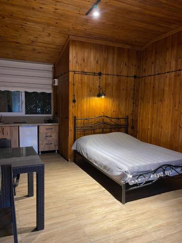 a bedroom with a bed and a wooden wall at Casamora in Edremit