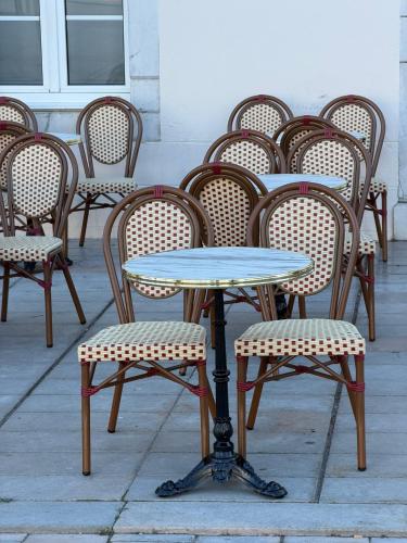 a group of chairs and a table and chairs at Hôtel-Restaurant de La Paix in Saint-Palais