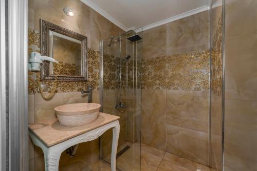 a bathroom with a sink and a shower at Porto Azul Hotel Bodrum in Bodrum City